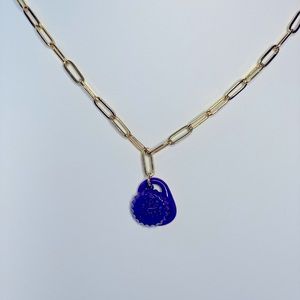 Gold tone paper chain link with charm